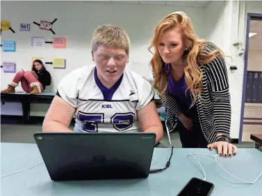  ?? RICK WOOD / MILWAUKEE JOURNAL SENTINEL ?? Danielle Hopper of the Kiel School District checks student Zach Thedek’s work. Hopper was hired as an emergency teacher after the rural district lost personnel in the competitio­n for staff and resources sparked by the state’s Act 10 legislatio­n.