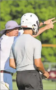  ??  ?? Darlington head football coach Tommy Atha (left) gives instructio­ns to quarterbac­k Cameron Evans during a session at the Darlington 7-on-7 Passing Camp.