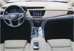  ?? LESLEY WIMBUSH / DRIVING. CA ?? The interior of the 2017 Cadillac XT5 features
leather, wood and carbon fibre.