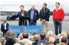  ?? ALEX WONG, GETTY IMAGES ?? Sen. Rand Paul, left, campaigns for Mitt Romney, right, Tuesday in Vandalia, Ohio, as Sen. Rob Portman and Rep. Paul Ryan look on.