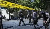  ?? ULET IFANSASTI / GETTY IMAGES ?? Indonesian police stand guard Monday outside the police station in Surabaya following a suicide attack by a family of five. Ten people were injured and the attackers were killed in the explosion.