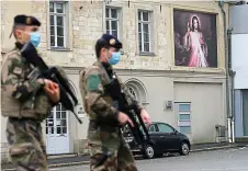  ?? REUTERS ?? High alert: Soldiers patrol near the Saint Gery church in Cambrai after France raised its security alert to the highest level