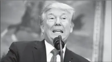  ?? The Associated Press ?? SPEAKING ON HEALTH CARE: In this Oct. 12, 2017 photo, President Donald Trump speaks before signing an executive order on health care in the Roosevelt Room of the White House in Washington. Striving to fulfill a campaign promise, the Trump...