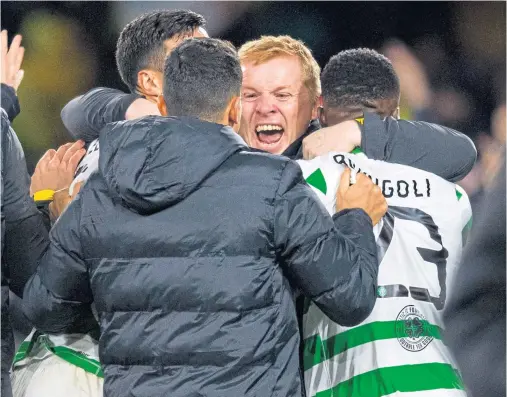  ??  ?? THE STUFF OF LEGEND: Manager Neil Lennon is mobbed at the end as Celtic register a thrilling victory against Italian opposition