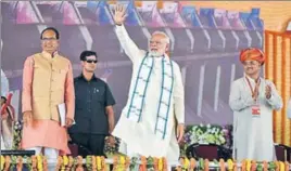  ?? MUJEEB FARUQUI/HT PHOTO ?? Prime Minister Narendra Modi waves during the inaugurati­on of Mohanpura dam in Madhya Pradesh’s Rajgarh on Saturday as state CM Shivraj Singh Chouhan (left) looks on.