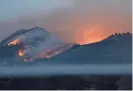  ?? AP ?? The 3,016-foot-tall Los Coches Mountain burns during a fire east of Nipomo, Calif., on Friday. Wildfires are blazing across the West as regions swelter under extreme heat.