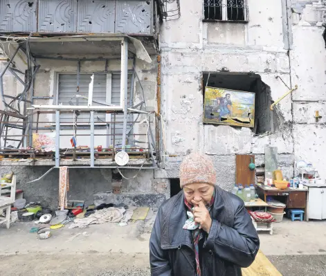  ?? ?? A local reacts outside their destroyed apartment building, Mariupol, Ukraine, Nov. 16, 2022.