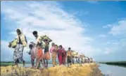  ?? AFP FILE ?? Rohingya Muslim refugees walk towards the Balukhali refugee camp after crossing the border with Bangladesh