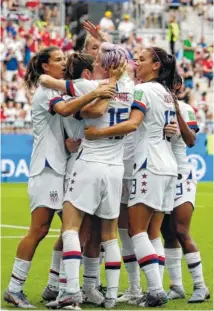  ?? AP PHOTO/ALESSANDRA TARANTINO ?? The United States’ Megan Rapinoe, front, celebrates with teammates after scoring the opening goal against Spain on a penalty kick.