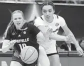  ?? CHARLIE NEIBERGALL/AP ?? South Carolina’s Brea Beal, right, and Louisville’s Hailey Van Lith go after a loose ball in the second half of Friday’s Final Four matchup in Minneapoli­s.