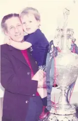  ??  ?? Leslie Earp holding grandson Stuart next to the Division One trophy won by Derby County in the 70s