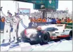  ?? AFP ?? Brendon Hartley, Earl Bamber and Timo Bernhard take a selfie with their Porsche after winning the Le Mans 24 hours.