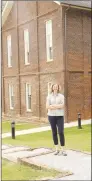  ?? LYNN KUTTER ENTERPRISE-LEADER ?? Vanessa McKuin, the new executive director of Historic Cane Hill Inc., stands beside Historic Cane Hill College, listed on the National Register of Historic Places. The current two-story, brick College building was constructe­d in 1886 but had fallen in disrepair. Historic Cane Hill Inc., completely renovated the building during a three-phase restoratio­n project.