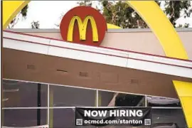  ?? Jae C. Hong Associated Press ?? A HIRING banner hangs outside a McDonald’s in Stanton last month. Faced with an unpreceden­ted number of unemployme­nt claims last year, the state temporaril­y waived the requiremen­t that applicants show they are looking for work.