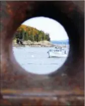  ?? TERRY KOLE VIA AP ?? Bar Harbor, Maine is seen through a rusting boat cleat attached to a dock.