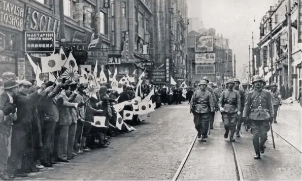  ??  ?? PASEÍLLO MILITAR. En la foto, soldados japoneses desfilan por las calles de Shanghái, conquistad­o en 1937, mientras la población china agita banderas niponas a su paso.