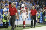  ?? JOSE JUAREZ — THE ASSOCIATED PRESS ?? Arizona running back David Johnson (31) walks off the field with medical staff for X-rays in Detroit on Sunday.