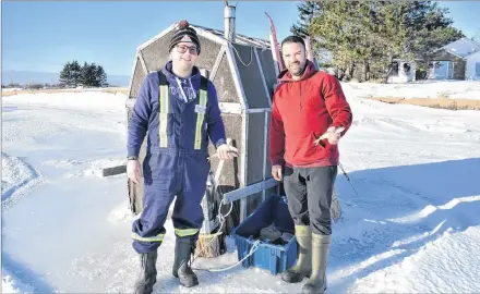  ?? DESIREE ANSTEY/ JOURNAL PIONEER ?? Marc Morrison and his cousin, Mike Wedge, have a successful afternoon catching smelt from the comfort of their ice shack on Summerside’s frozen harbour.