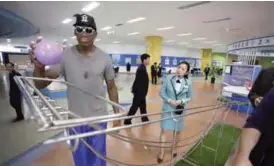  ??  ?? PYONGYANG: Former NBA basketball star Dennis Rodman visits the Sci-Tech Complex yesterday. — AP