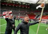  ??  ?? Pitch invasion…United fans on the Old Trafford pitch