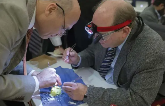  ?? CHRIS SO/TORONTO STAR ?? The Hospital for Sick Children’s head of cardiovasc­ular surgery, Dr. Glen Van Arsdell, left, works with pediatric cardiac surgeon Dr. Erle Austin from Louisville, Ky., on a 3D-printed heart.