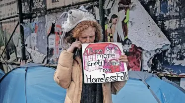  ?? | EPA ?? A HOMELESS woman protests against police clearing a street encampment in New York. The city’s mayor has directed authoritie­s to remove mentally ill homeless people from the streets if they are thought to be a danger.