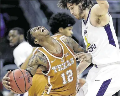  ?? CHARLIE RIEDEL / AP ?? Texas sophomore Kerwin Roach, colliding Thursday with West Virginia’s Nathan Adrian in the quarterfin­al round of the Big 12 tourney in Kansas City, missed too many easy shots to count this season, as did teammate Eric Davis.