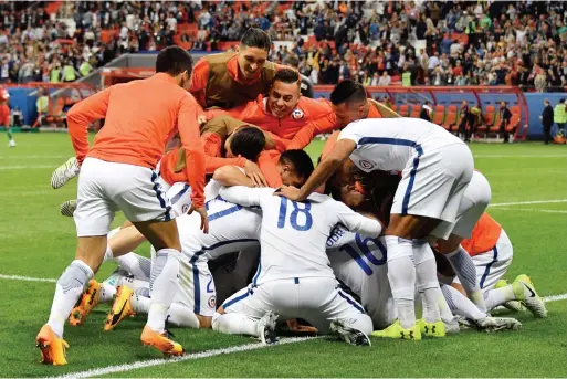  ?? — AFP ?? Chile players celebrate after they won the Confederat­ions Cup semifinal against Portugal at the Kazan Arena.