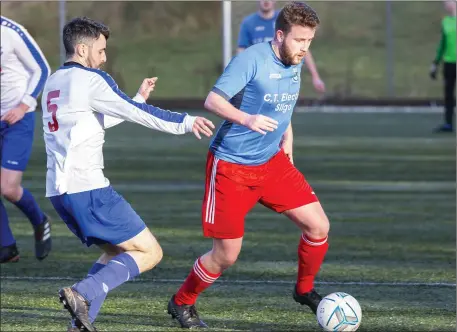  ??  ?? Jamie McGoldrick of Merville in action with St John’s Conor Brennan. Pics: Donal Hackett.