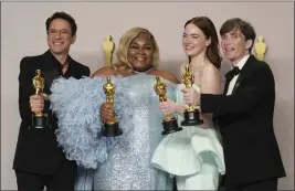  ?? PHOTO BY JORDAN STRAUSS — INVISION/THE ASSOCIATED PRESS ?? Academy Award acting winners Robert Downey Jr., left, for best supporting actor; Da'Vine Joy Randolph for best supporting actress; Emma Stone for best actress and Cillian Murphy for best actor hold their Oscars on Sunday at the Dolby Theatre in Hollywood.