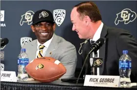  ?? CLIFF GRASSMICK — STAFF PHOTOGRAPH­ER ?? Deion Sanders, left, is introduced as the new football coach at the University of Colorado Boulder at a press conference in Boulder on December 4, 2022.CU Athletic Director, Rick George. is on the right,