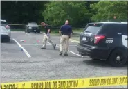  ?? CELIA SEUPEL — DAILY FREEMAN FILE ?? JUNE 1: Police are shown in the New Paltz parking lot where Andrew Kaartine was fatally shot by his son, Jeremy, 22, of Saugerties. The son later committed suicide after being chased by police.