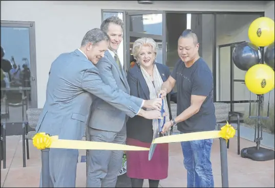  ?? Erik Verduzco Las Vegas Review-Journal @Erik_Verduzco ?? From left, Economic and Urban Developmen­t director Bill Arent, Vice President for The Wolff Company Nate Carlson, Las Vegas Mayor Carolyn Goodman and Zappos CEO Tony Hsieh cut the ribbon in 2018 for Fremont9, a downtown apartment complex.