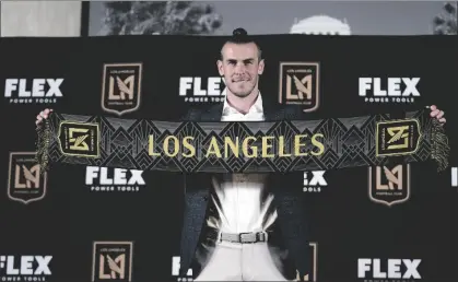  ?? AP PHOTO/MARCIO JOSE SANCHEZ ?? Gareth Bale poses for photos after being introduced as a new member of the Los Angeles FC MLS soccer club on Monday in Los Angeles.