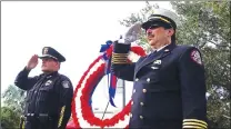  ??  ?? Coral Springs Police Chief Clyde Parry, left, and Coral Springs/parkland Fire and Rescue Chief Frank Babinec salute during the 9/11 memorial service in Coral Springs, Fla., on Tuesday.