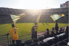  ?? Scott Strazzante / The Chronicle 2017 ?? Right: A’s fans wave flags at the Coliseum, the team’s home since 1968. The site on I-880 remains a possibilit­y for a new ballpark.