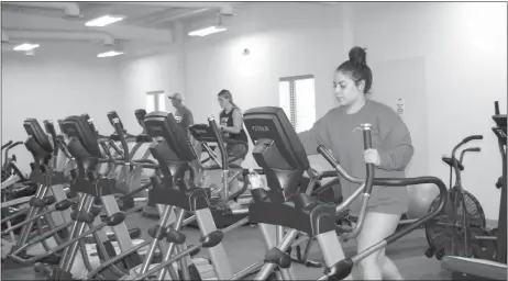  ?? Mona Weatherly ?? Using the treadmills and elliptical­s at the Melham Wellness Center are, from left in back, Mike Bell, Cece Killinger and, in front, Stephanie Guevara.