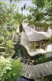  ??  ?? Blackwood Manor has three koi-filled water features, each on a different level of the home, with glass panels for underwater viewing in strategic rooms.