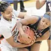  ?? KARLMERTON­FERRON / BALTIMORE SUN ?? Morgan State’s Dahnye Redd battles Howard’s Brooklyn FortDavis for possession of the ball Saturday.