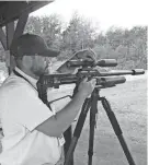  ?? PAUL A. SMITH / MILWAUKEE JOURNAL SENTINEL ?? Chris Turek of Travers City, Michigan, sights in a .30-caliber air rifle at a conference of the Associatio­n of Great Lakes Outdoors Writers.