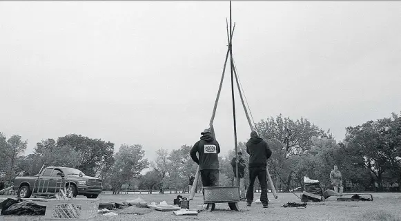  ?? PHOTOS: BRANDON HARDER ?? The last three poles of the original and final teepee come down at the Justice for Our Stolen Children camp across from the Saskatchew­an Legislativ­e Building.