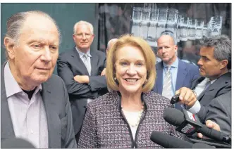  ?? AP PHOTO ?? Seattle Hockey Partners David Bonderman, left, and Seattle Mayor Jenny Durkan talk to the media as they leave a meeting at National Hockey League headquarte­rs, Tuesday.