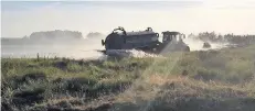  ??  ?? The tractors spraying water out to battle the moorland fire