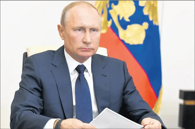  ?? ALEXEI NIKOLSKY/KREMLIN POOL PHOTO ?? Russian President Vladimir Putin addresses the nation Monday via video conference outside Moscow, Russia.