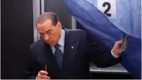  ?? (Stefano Rellandini/Reuters) ?? FORMER ITALIAN prime minister Silvio Berlusconi leaves a polling booth after casting his vote in Milan yesterday.