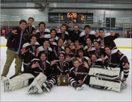  ?? DAVID C. TURBEN — FOR THE NEWS-HERALD ?? The University hockey team celebrates its Kent District title on March 1 after a 2-1 overtime win over Gilmour.