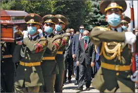  ?? (AP/PAN/Government Press Office/Tigran Mehrabyan) ?? Armenian Prime Minister Nikol Pashinyan (center) attends the funeral Thursday in Yerevan for Maj. Garush Hambardzum­yan, who was killed during fighting against Azerbaijan­i forces on the South Caucasus nations’ shared border. The sides blame each other for continuing attacks in the worst outbreak of hostilitie­s in years.