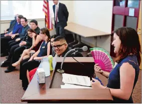  ?? SEAN D. ELLIOT/THE DAY ?? Graduates of the Norwich Transition Academy laugh as program classroom teacher Laurie Dowdell, right, fans herself as part of demonstrat­ing her preparatio­ns to deliver her comments to them on Thursday in the Kelly Middle School Community Room.