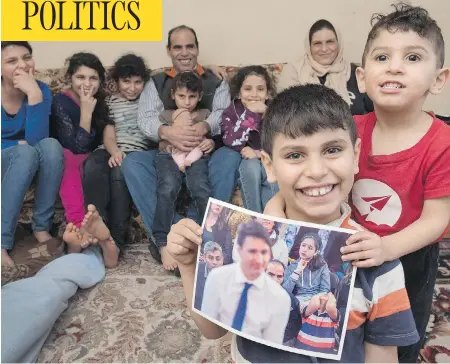  ?? STEPHEN MACGILLIVR­AY / THE CANADIAN PRESS ?? Abdel Kader Al Shaikh, 10, holds a photo taken of him during Prime Minister Justin Trudeau’s recent visit to Fredericto­n, N.B., on Saturday. The Canadian Press photo struck a chord with social media users, with some interpreti­ng the boy’s expression as...