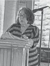  ?? PHOTOS BY GINNY UNDERWOOD ?? Dr. Delores Subia BigFoot, an Oklahoma City metro-area child psychologi­st, speaks at a remembranc­e service coordinate­d by the Oklahoma Indian Missionary Conference of the United Methodist Church.
Top: The D.D. Etchieson United Methodist Choir sings at a remembranc­e service for youths who experience­d the Native American boarding school era.